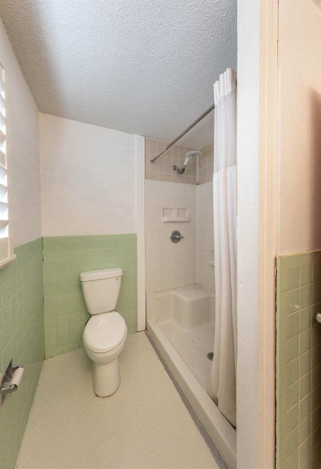 5415 8th Street Lubbock, TX 79416 - Photo 21 of 27 a bathroom with a toilet and a shower
