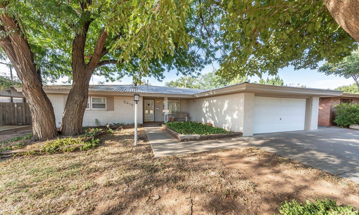 5415 8th Street Lubbock, TX 79416 - Photo 25 of 27 a view of a house with backyard and a tree