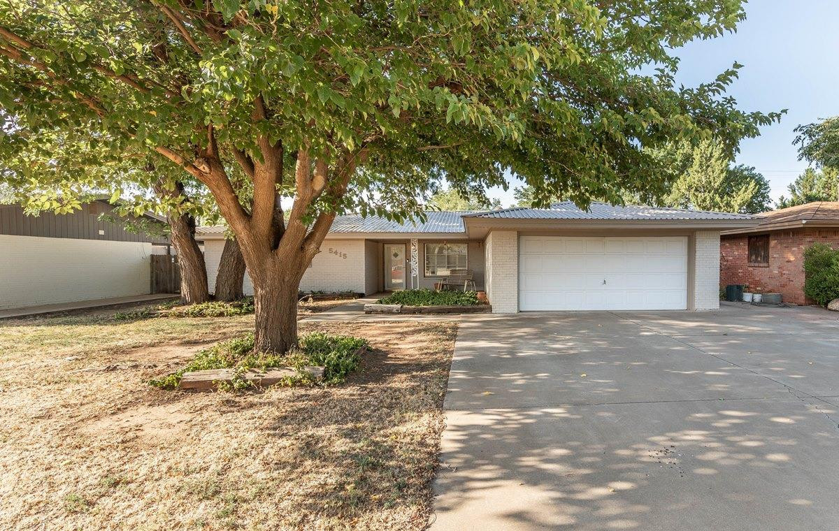 5415 8th Street Lubbock, TX 79416 - Photo 26 of 27 a view of a house with a yard and large tree