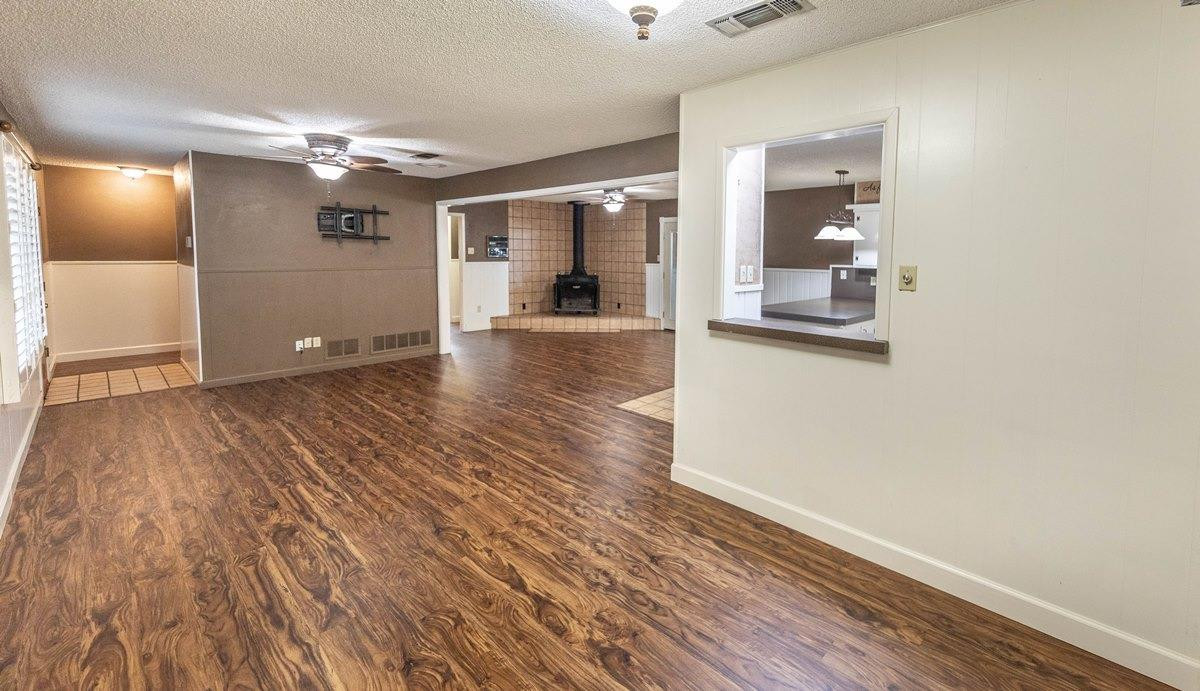 5415 8th Street Lubbock, TX 79416 - Photo 4 of 27 wooden floor in a hall with an empty room