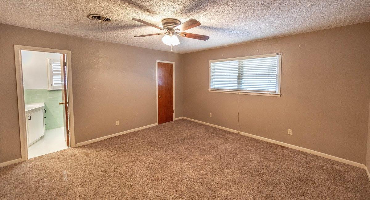 5415 8th Street Lubbock, TX 79416 - Photo 8 of 27 an empty room with windows and fan