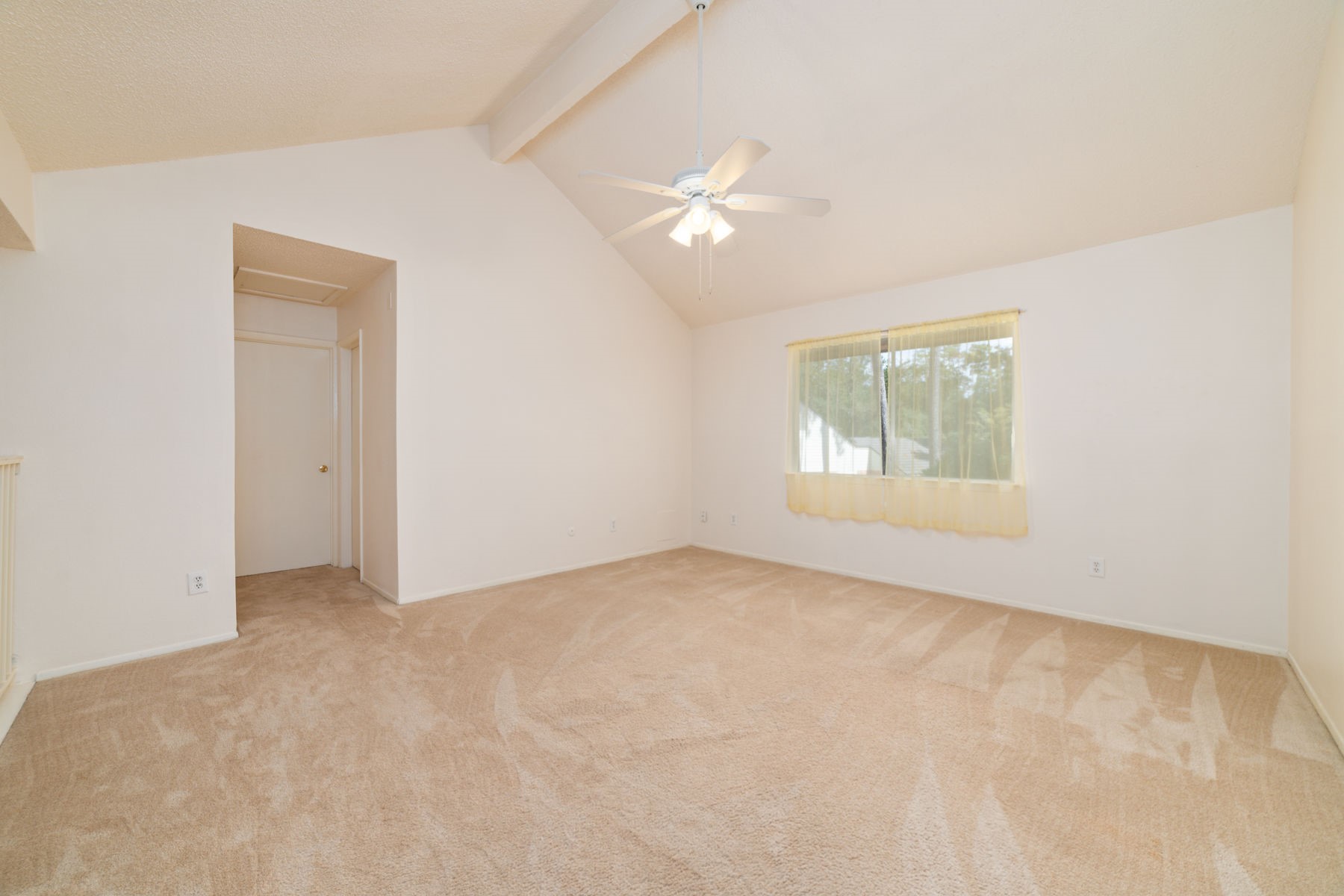 25402 Mill Pond Lane Spring, TX 77373 - Photo 21 of 24 This is a spacious room with vaulted ceilings, neutral carpeting, and a ceiling fan. A large window provides natural light. Great for a play area, game room, or an office.