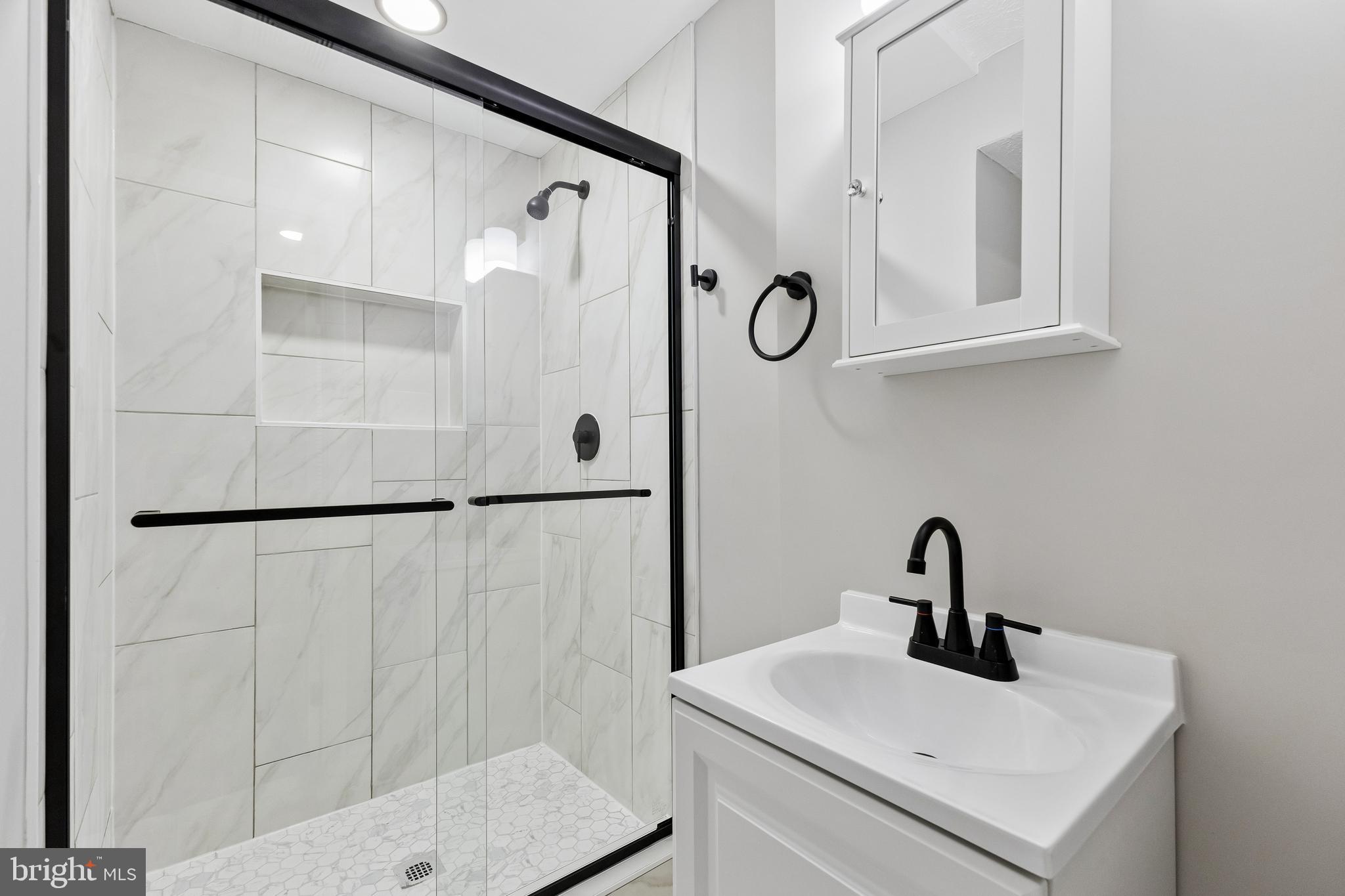 8317 Brookvale Court Springfield, VA 22153 - Photo 29 of 33 a bathroom with a sink and mirror