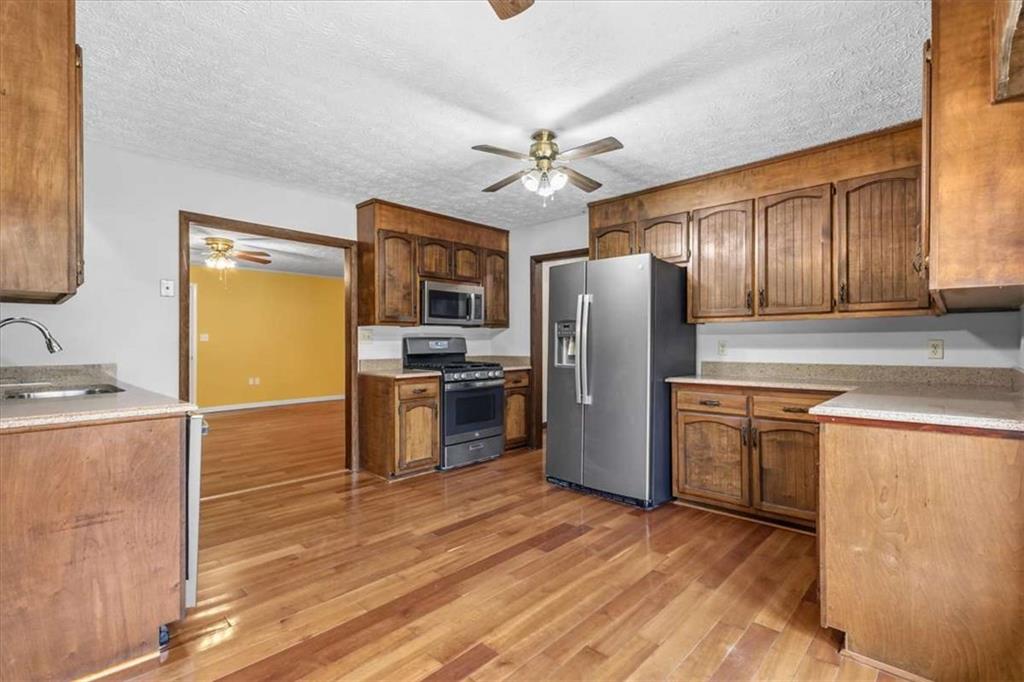 202 Ridgewood Road Cedartown, GA 30125 - Photo 12 of 39 a kitchen with granite countertop stainless steel appliances and wooden cabinets
