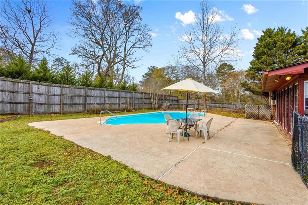 202 Ridgewood Road Cedartown, GA 30125 - Photo 6 of 39 a view of a backyard with swimming pool and sitting area