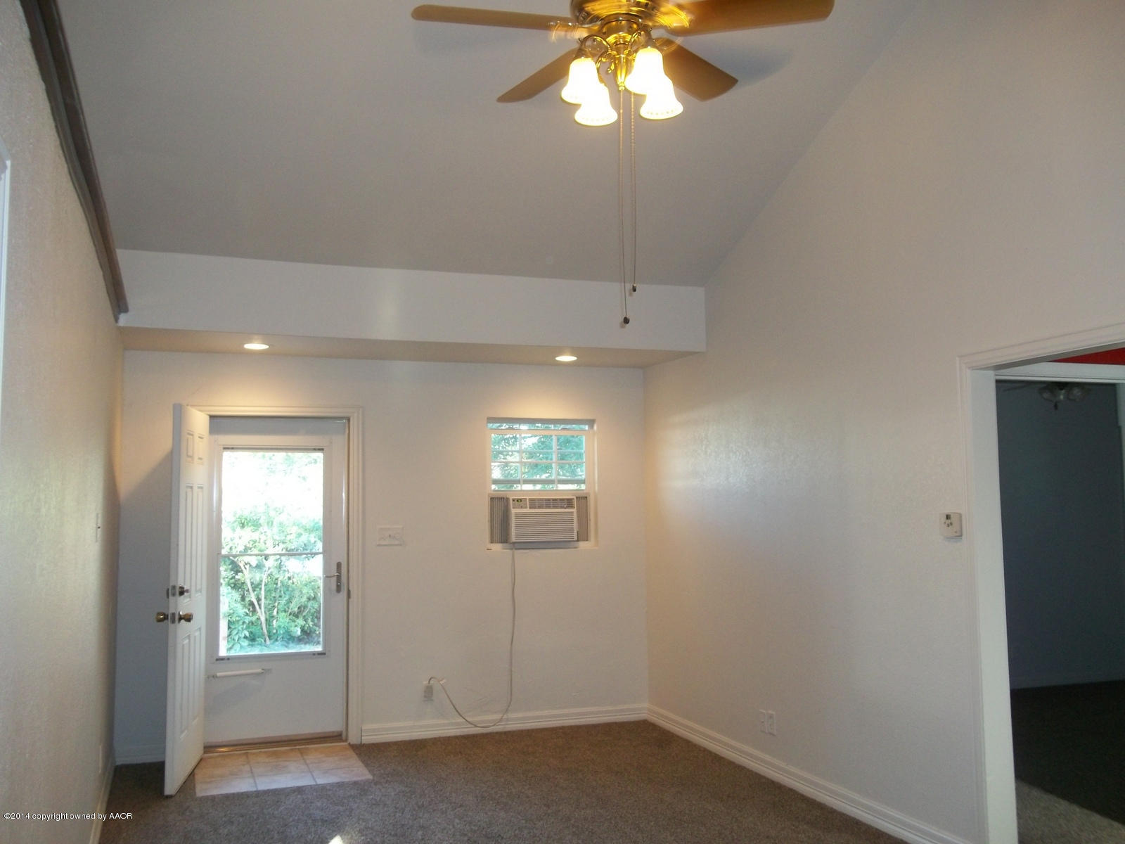4208 South Hughes Street Amarillo, TX 79110 - Photo 4 of 16 an empty room with windows and chandelier fan