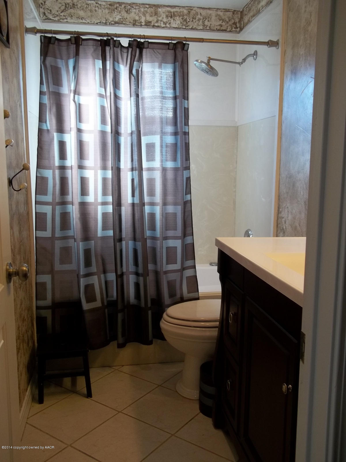 4208 South Hughes Street Amarillo, TX 79110 - Photo 6 of 16 a bathroom with a toilet a sink and shower