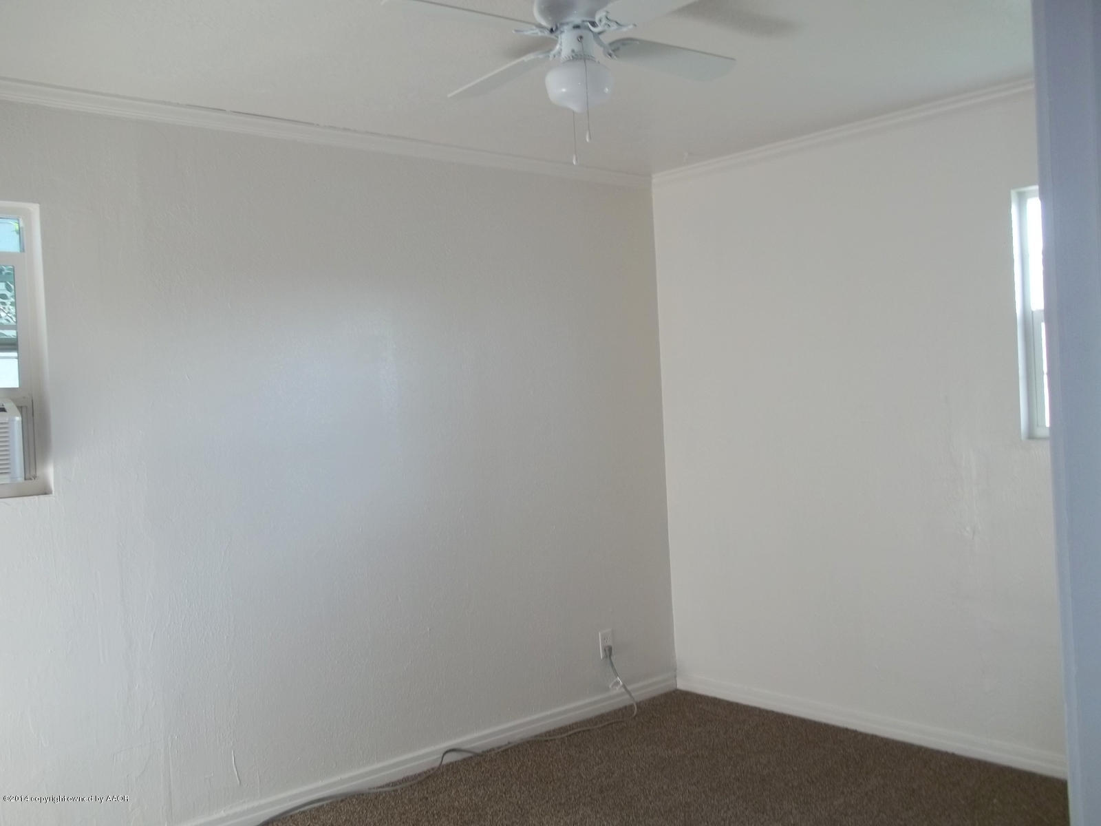 4208 South Hughes Street Amarillo, TX 79110 - Photo 8 of 16 an empty room with a fan and a window