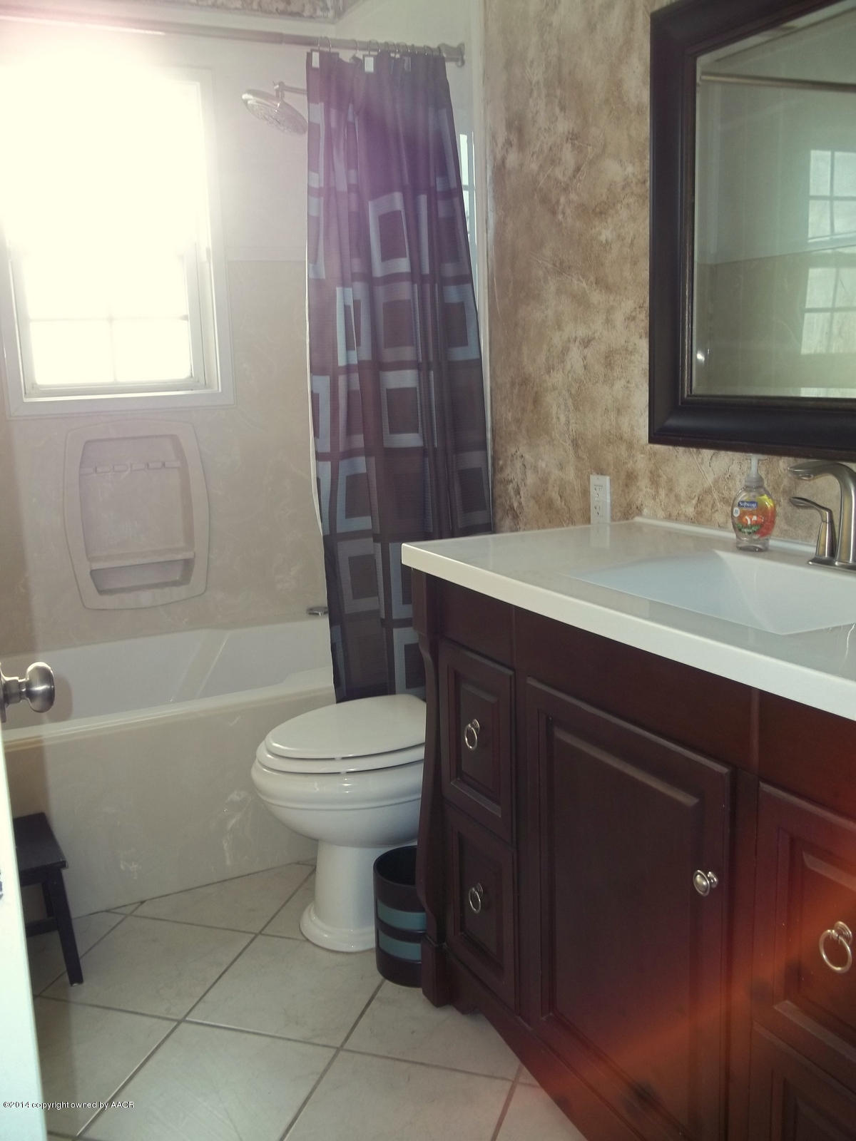 4208 South Hughes Street Amarillo, TX 79110 - Photo 9 of 16 a bathroom with a sink a toilet and shower