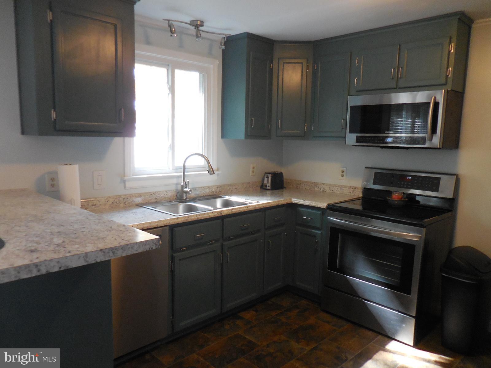 250 Outpost Road Luray, VA 22835 - Photo 17 of 25 a kitchen with a sink stove and microwave