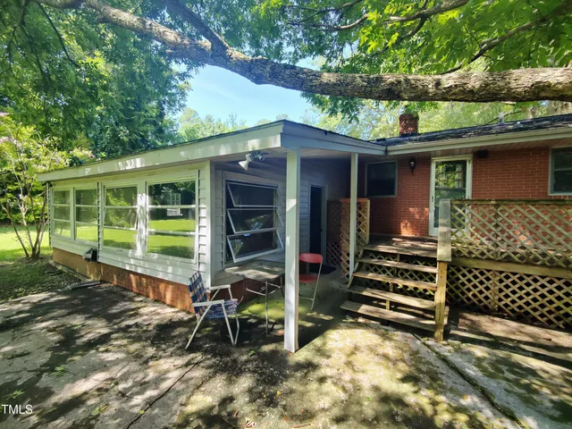 a view of a house with a door and wooden floor