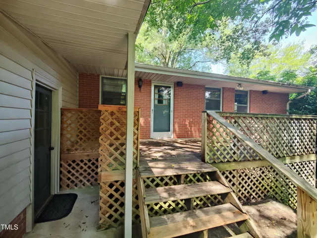 a view of balcony with wooden floor and fence