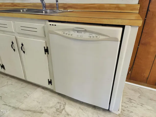 a white refrigerator freezer and a stove sitting inside of kitchen