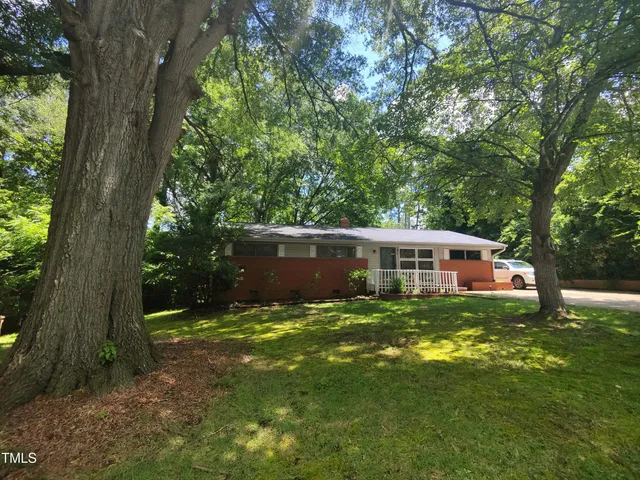 a backyard of a house with table and chairs