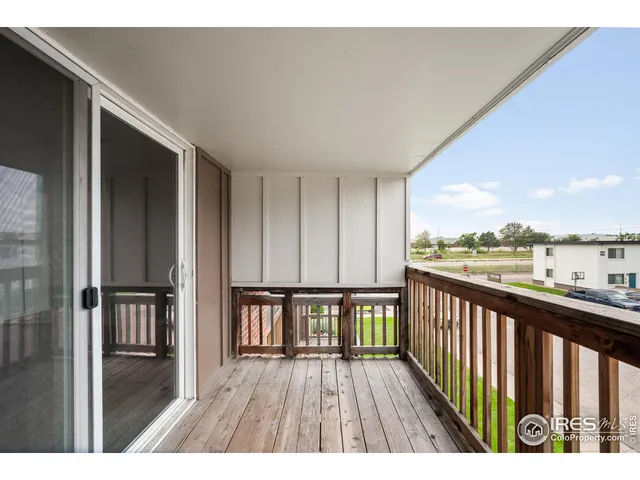 a view of a balcony with wooden floor and outdoor space