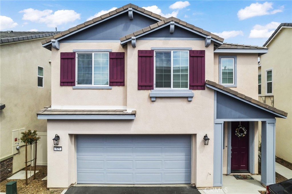 525 Pablo Road Lake Elsinore, CA 92530 - Photo 1 of 1 a front view of a house with a garage and balcony