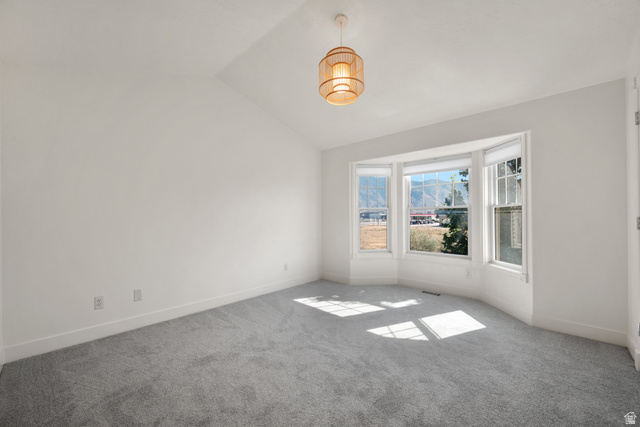 463 North 2400 West, Unit 7 Springville, UT 84663 - Photo 14 of 22 Vaulted ceiling, bay window, natural light, wall-to-wall carpeting, and a drum pendant light fixture