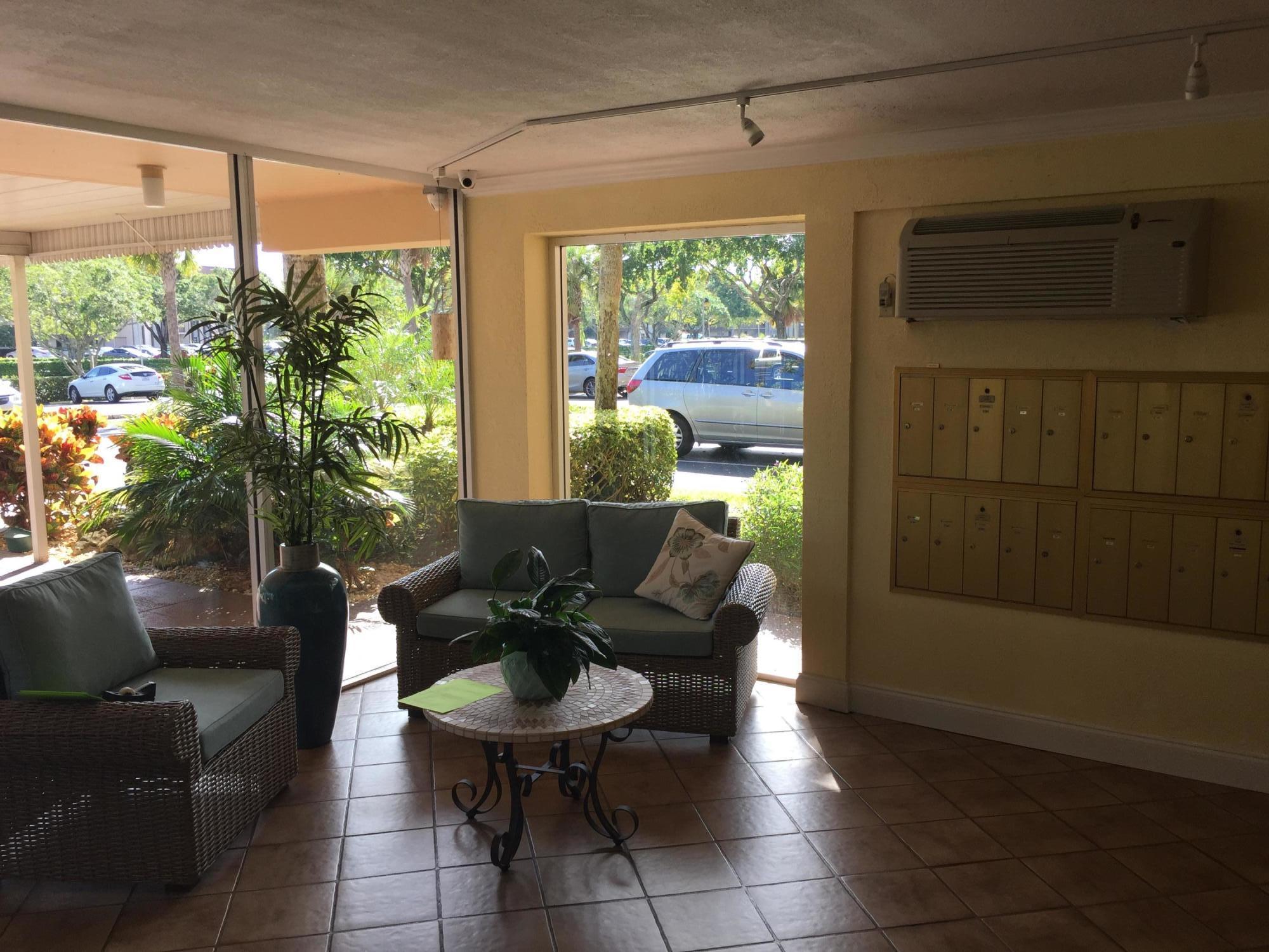 6161 Northwest 2nd Avenue, Unit 421 Boca Raton, FL 33487 - Photo 25 of 34 Building Foyer Sitting Area