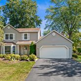 a front view of house with yard and green space