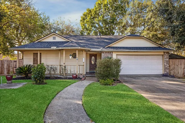 a front view of a house with a yard and outdoor seating