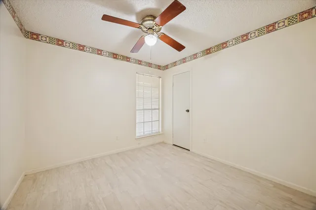 a bathroom with a granite countertop toilet a sink and a mirror