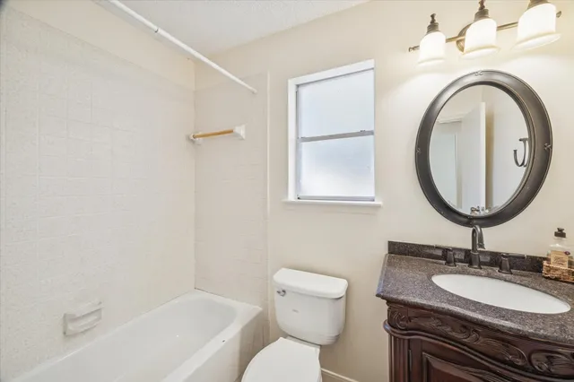 a view of a big yard with an tree and wooden fence