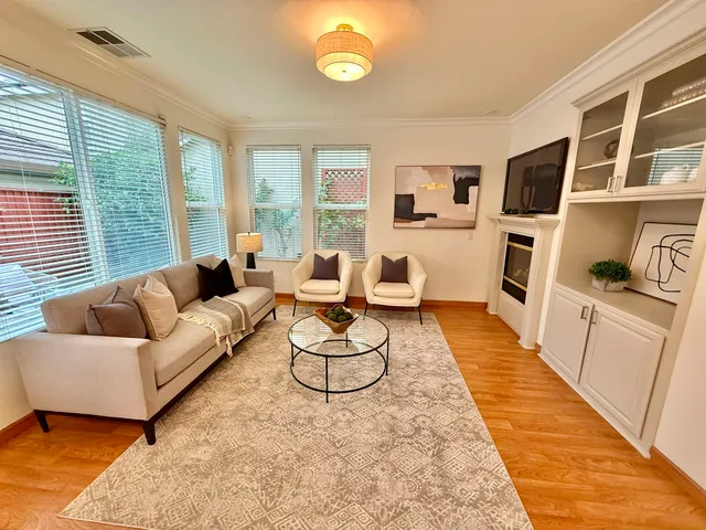 a living room with furniture rug and a table
