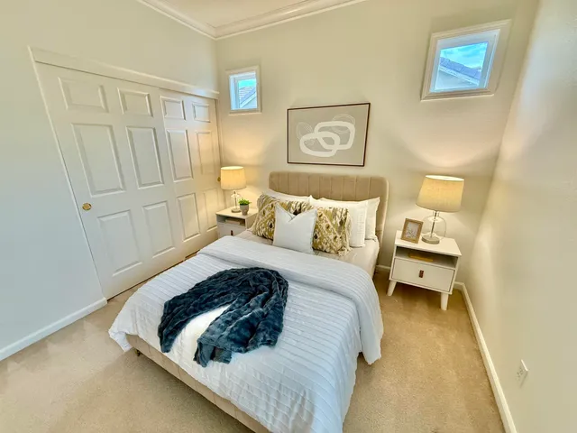 a bedroom with a bed and a painting on the wall