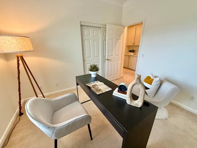 a living room with couches and rug with wooden floor
