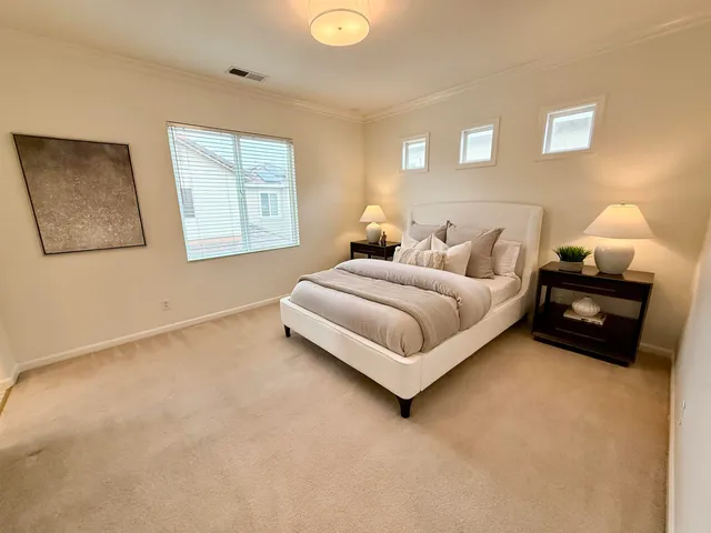 a spacious bedroom with a bed and a window