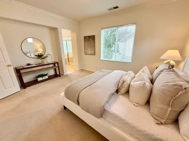 a bedroom with a bed and window