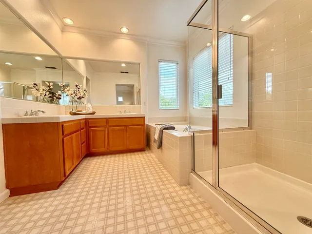 a large bathroom with a large tub shower and sink