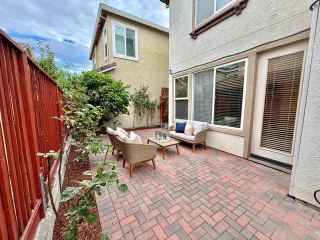 a backyard of a house with outdoor seating