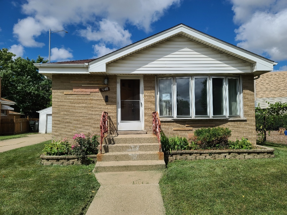 5146 Michigan Avenue Schiller Park, IL 60176 - Photo 1 of 15 a front view of a house with a yard