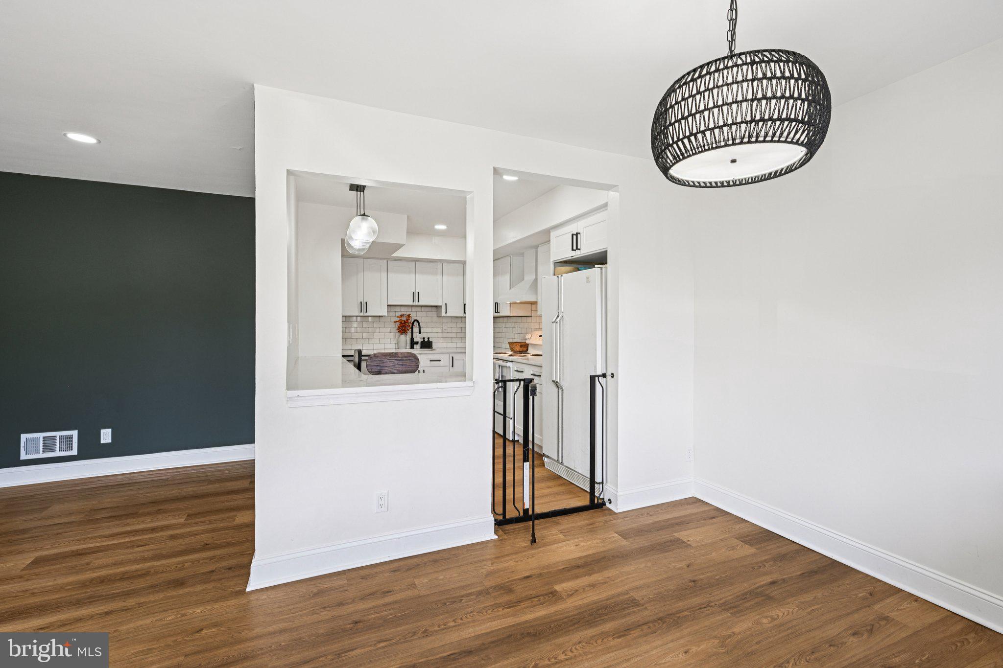 115 East Kings Highway, Unit 319 Maple Shade, NJ 08052 - Photo 12 of 37 a view of a room with wooden floor and kitchen view