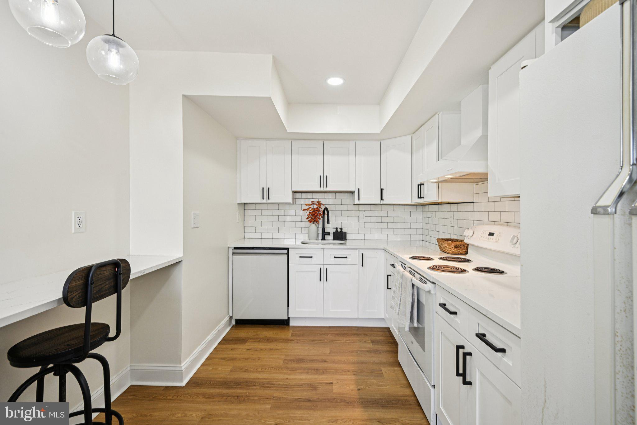 115 East Kings Highway, Unit 319 Maple Shade, NJ 08052 - Photo 14 of 37 a kitchen with granite countertop white cabinets and white appliances