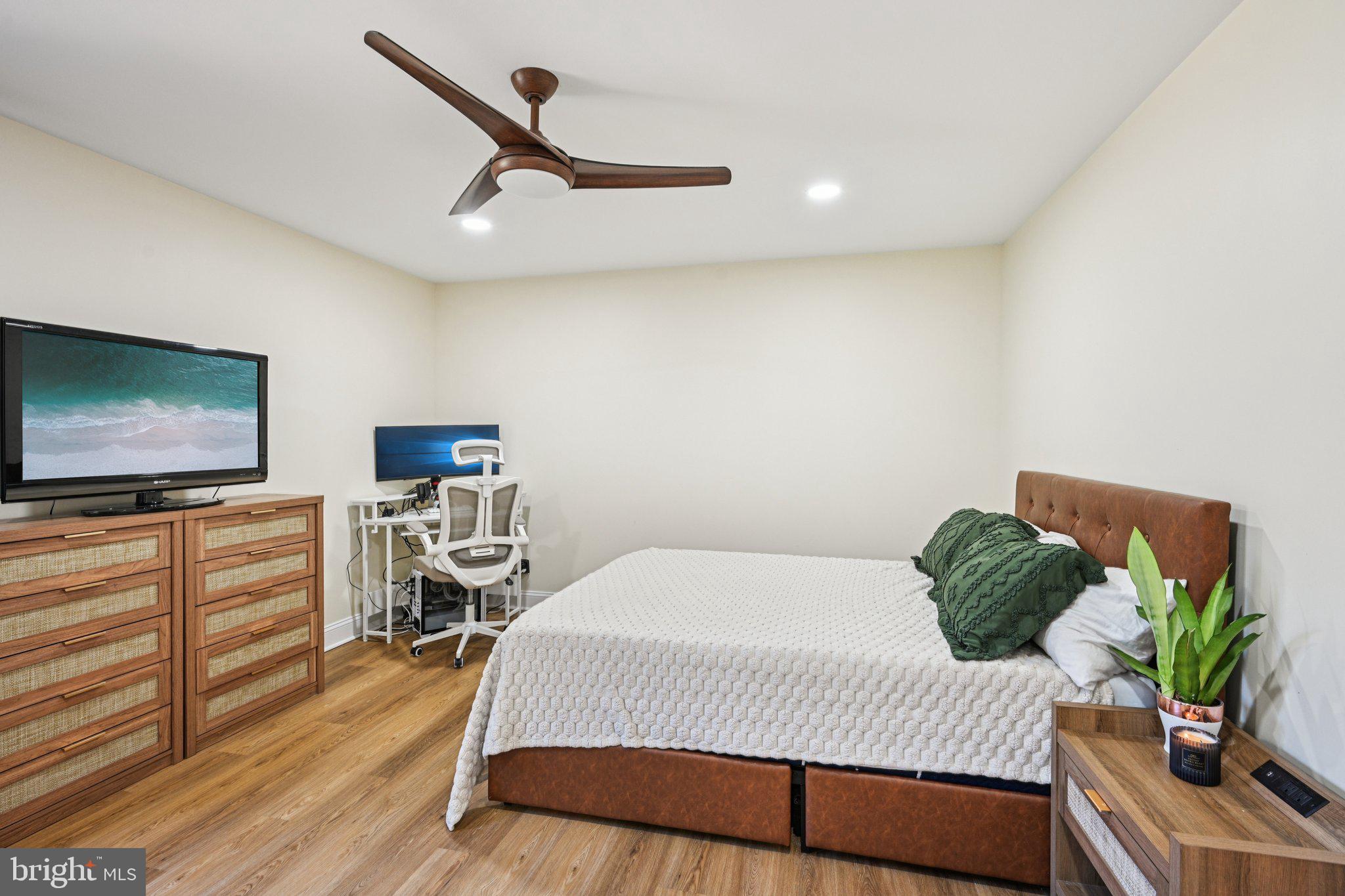 115 East Kings Highway, Unit 319 Maple Shade, NJ 08052 - Photo 17 of 37 a bedroom with a bed and a flat screen tv