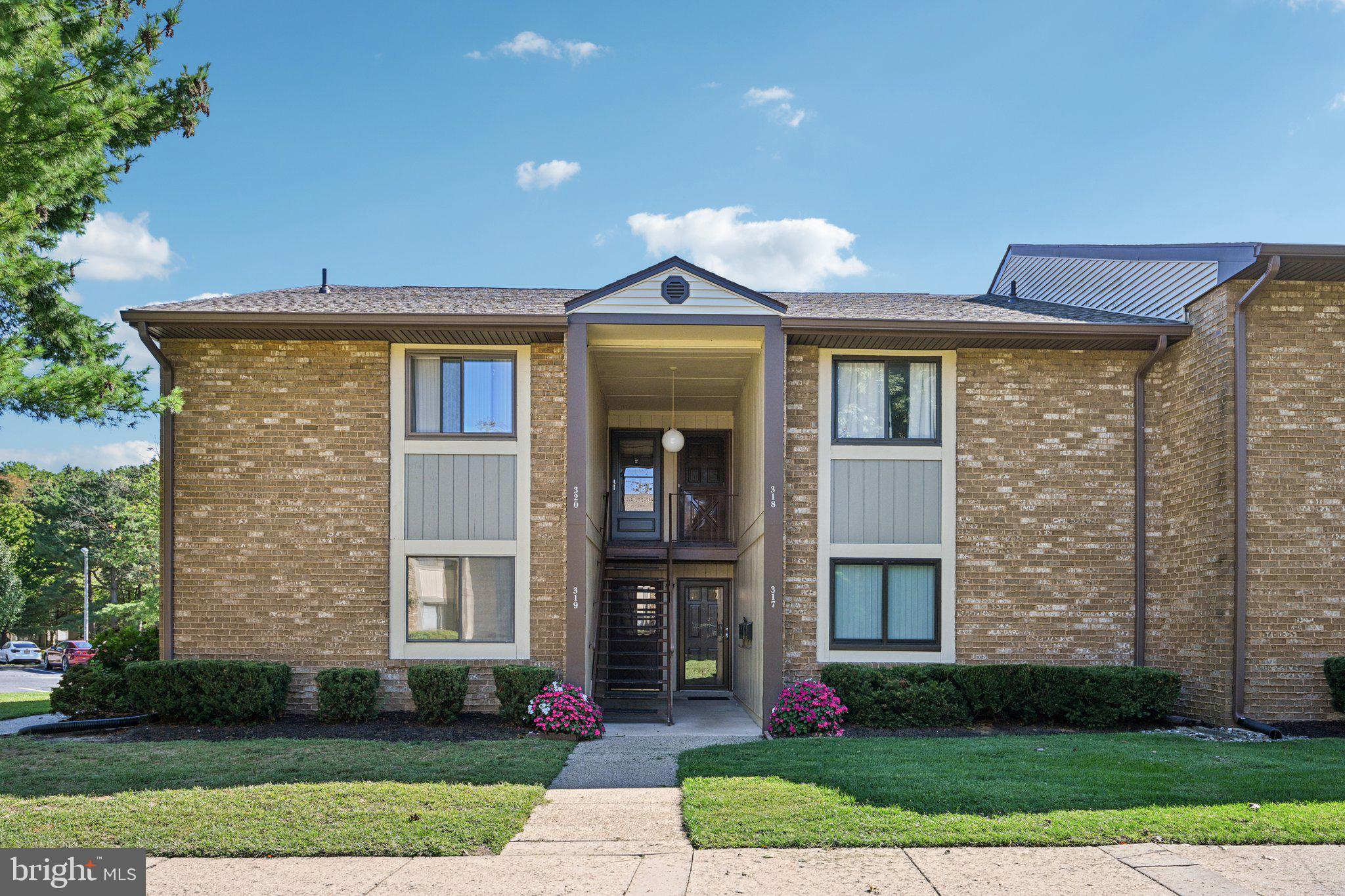 115 East Kings Highway, Unit 319 Maple Shade, NJ 08052 - Photo 2 of 37 a front view of a house with a yard