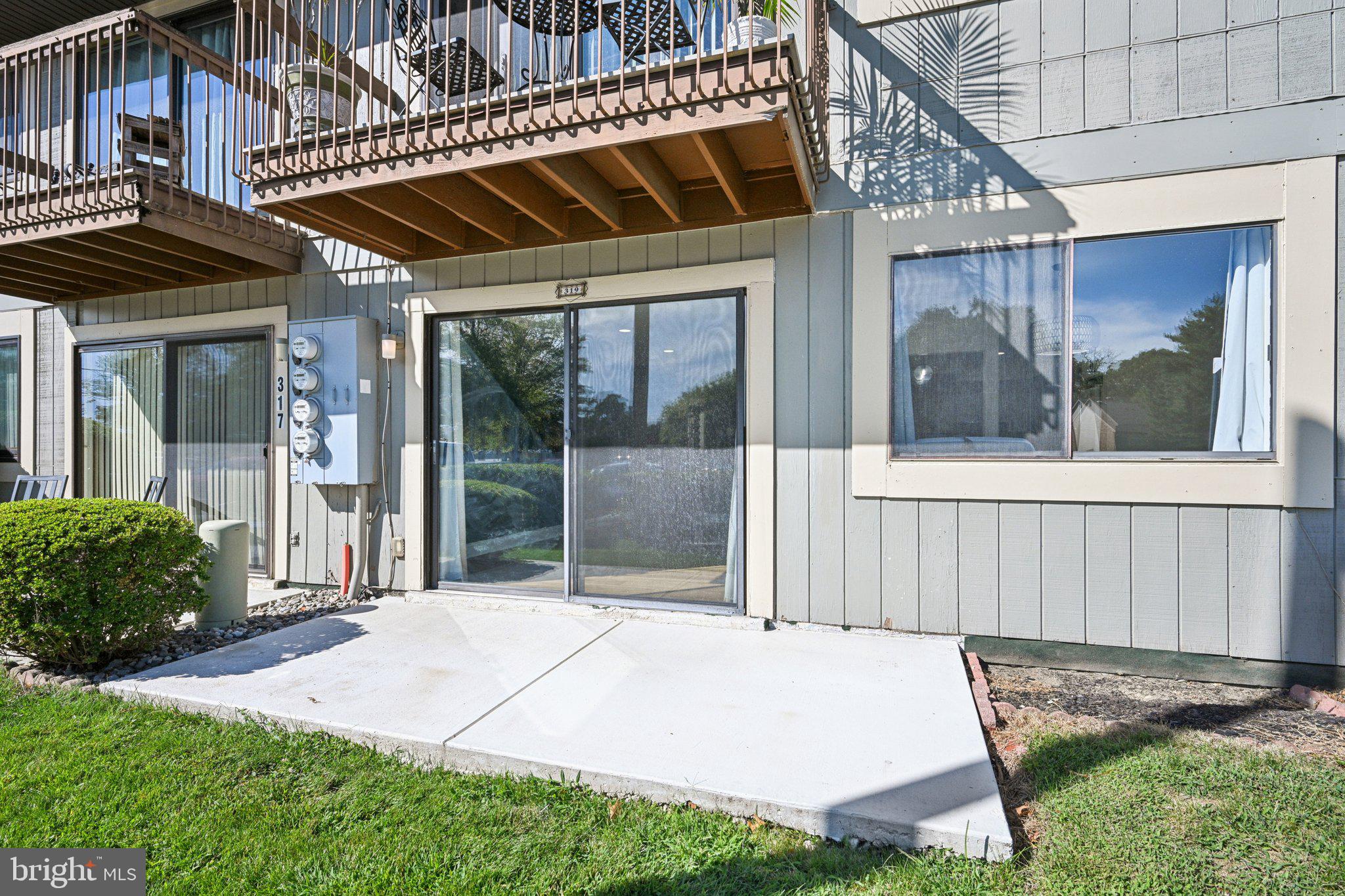115 East Kings Highway, Unit 319 Maple Shade, NJ 08052 - Photo 26 of 37 a patio with a table and chairs and potted plants