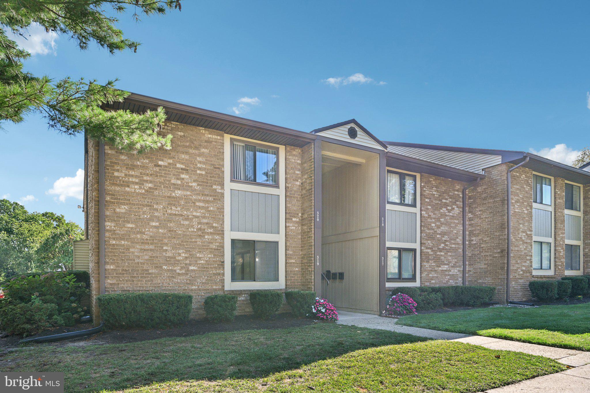 115 East Kings Highway, Unit 319 Maple Shade, NJ 08052 - Photo 27 of 37 a front view of a house with a yard