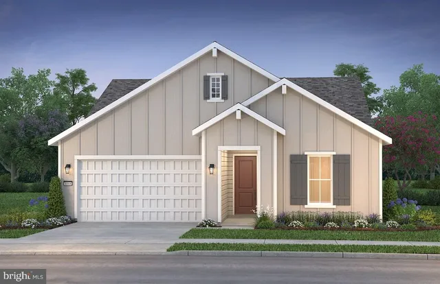 a view of a white house with large windows and plants