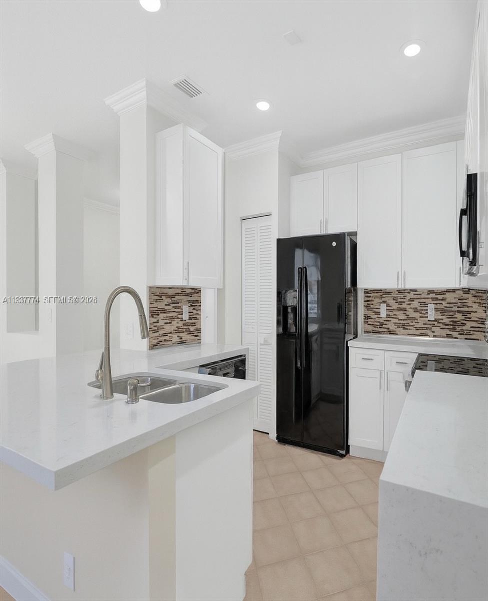 797 Chimney Rock Road, Unit 797 Weston, FL 33327 - Photo 12 of 26 a kitchen with a refrigerator and a sink