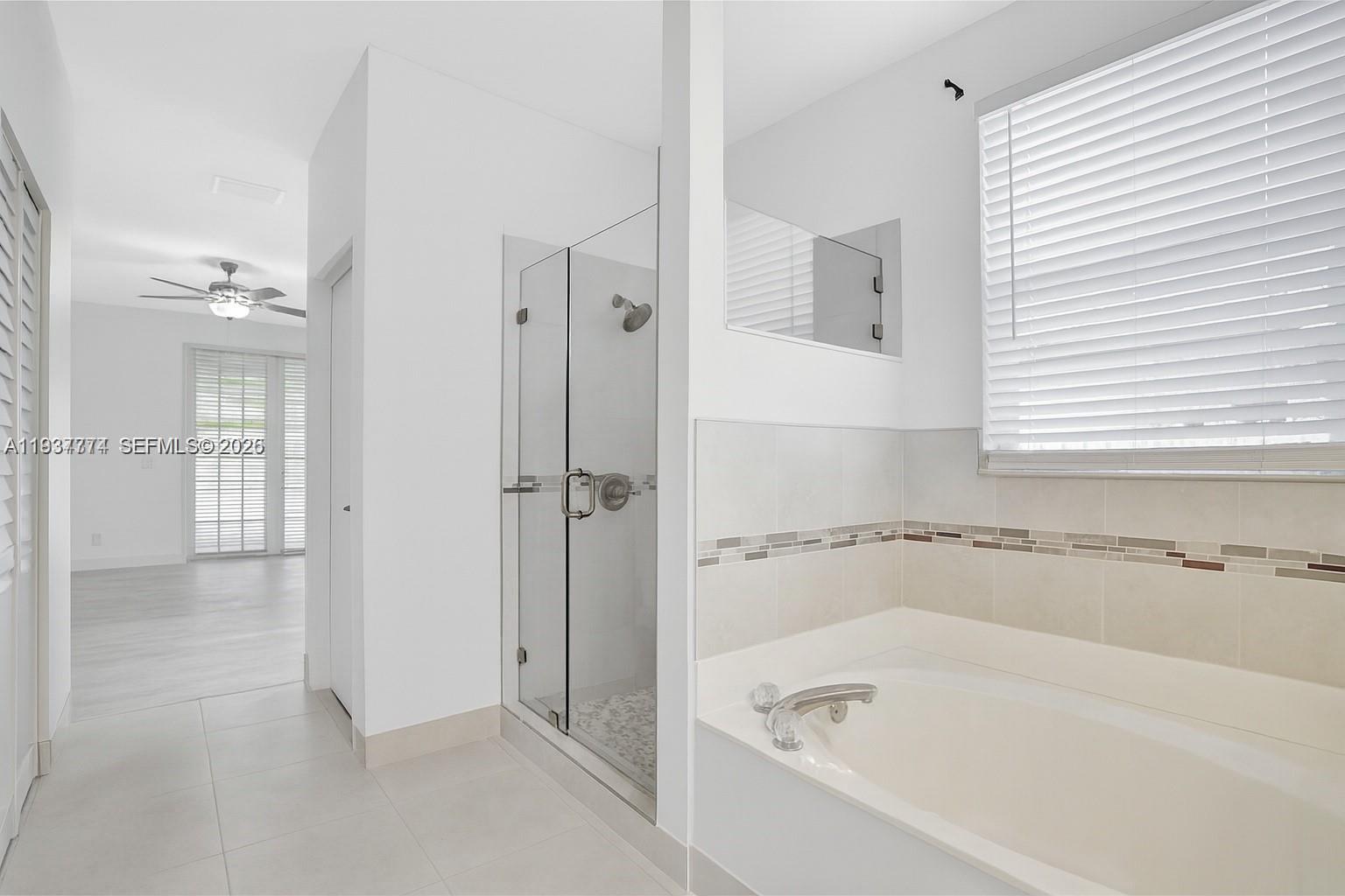 797 Chimney Rock Road, Unit 797 Weston, FL 33327 - Photo 19 of 26 a bathroom with a bathtub and a shower