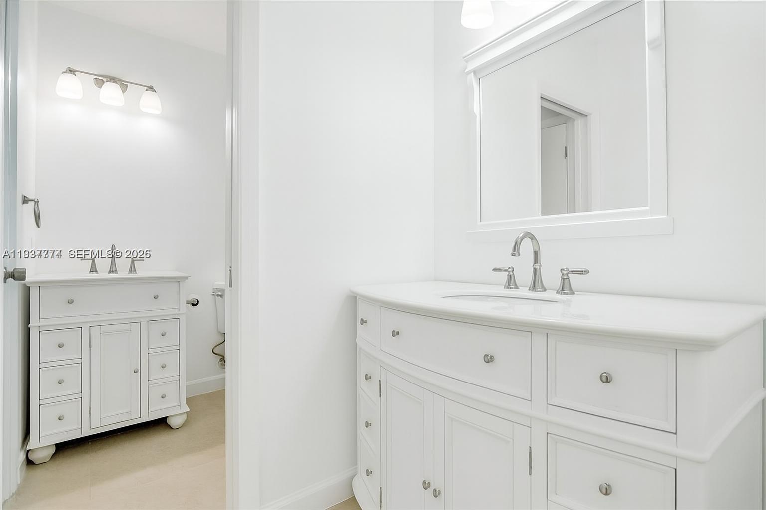 797 Chimney Rock Road, Unit 797 Weston, FL 33327 - Photo 21 of 26 a bathroom with a sink vanity and mirror
