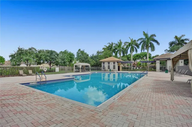 a view of a swimming pool with a yard