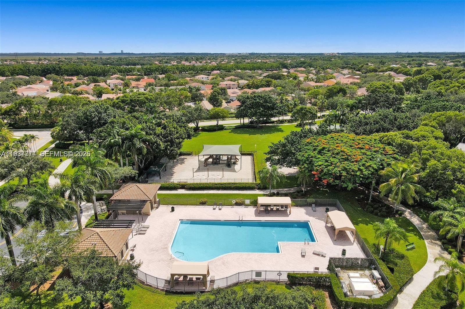 797 Chimney Rock Road, Unit 797 Weston, FL 33327 - Photo 6 of 26 an aerial view of a house with a garden and lake view