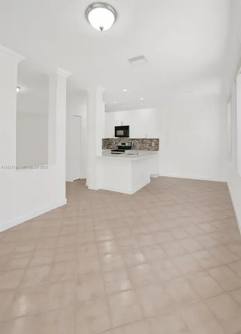 a view of kitchen with stainless steel appliances cabinets