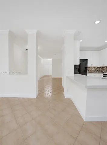 a view of a kitchen with a sink and a refrigerator