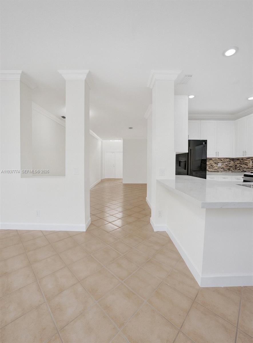 797 Chimney Rock Road, Unit 797 Weston, FL 33327 - Photo 10 of 26 a view of a kitchen with a sink and a refrigerator