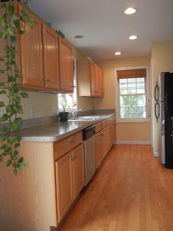 113 Appleton Street Springfield, MA 01108 - Photo 14 of 40 a kitchen with granite countertop a sink cabinets stainless steel appliances and a window